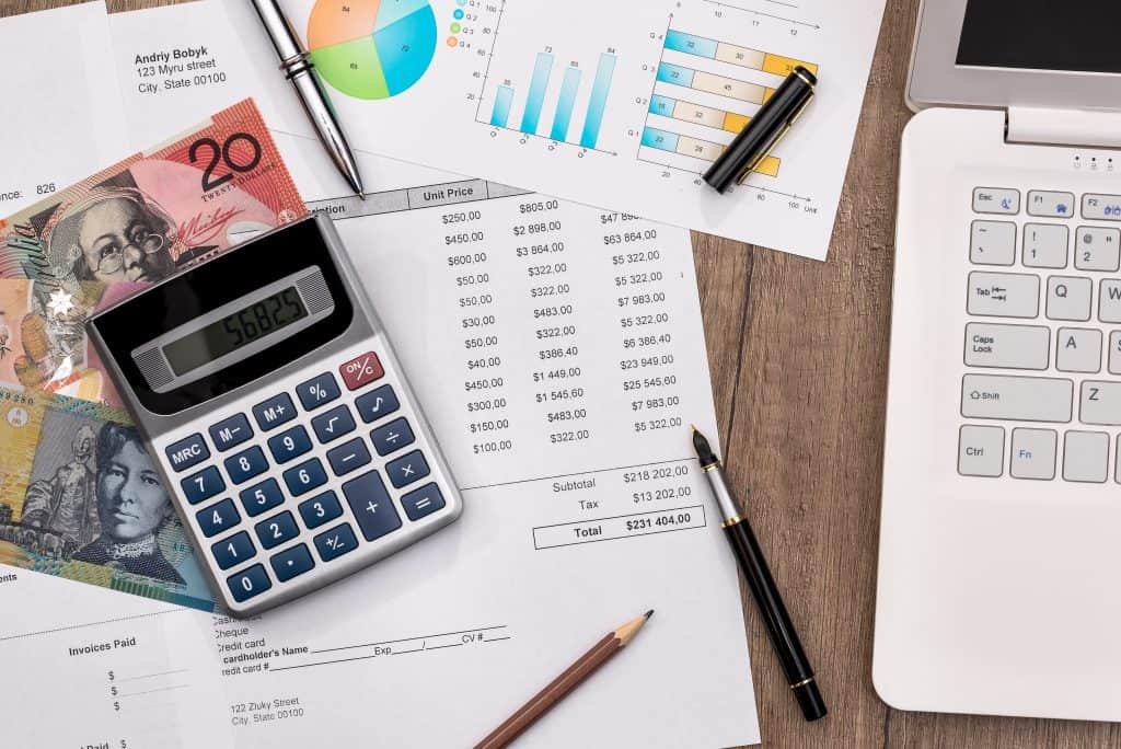 calculator and medical bills on a desk